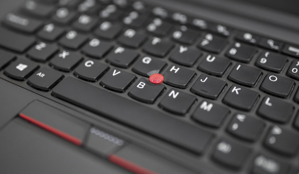 Lenovo Thinkpad laptop with red button in the middle of the keyboard.
