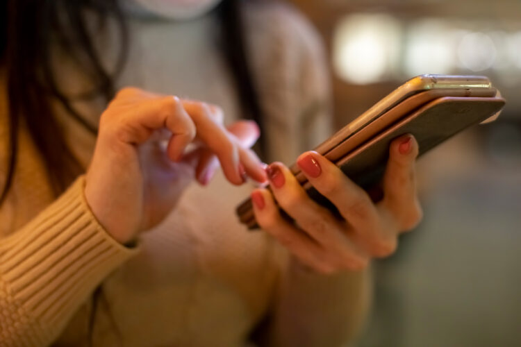 female hands are typing in the smartphone. 