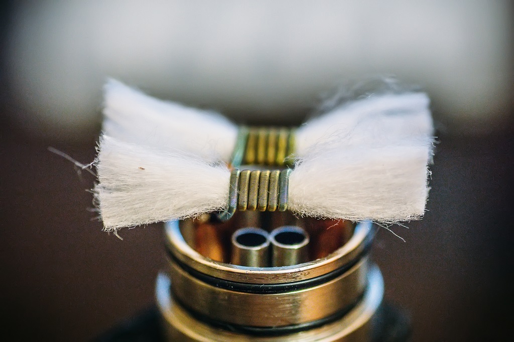 Vape RDA or e-cigarette for vaping with coils and wicking cotton.
