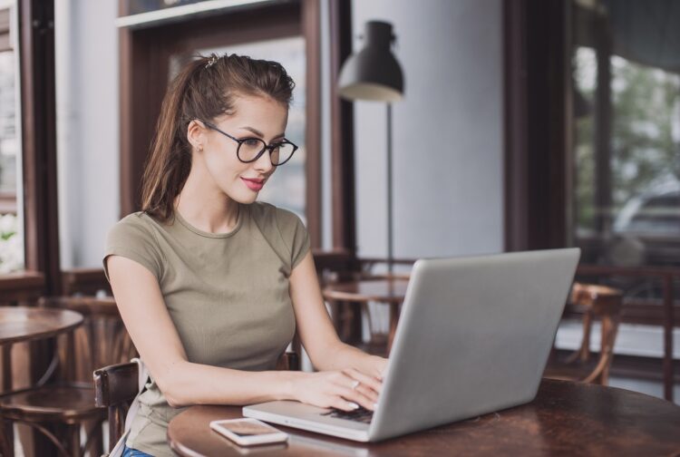 attractive woman using laptop at cafe. 