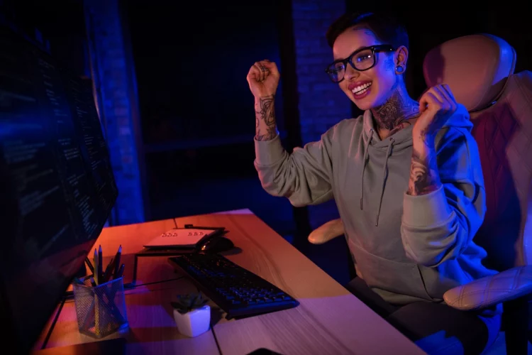 an excited female programmer celebrating her accomplishment