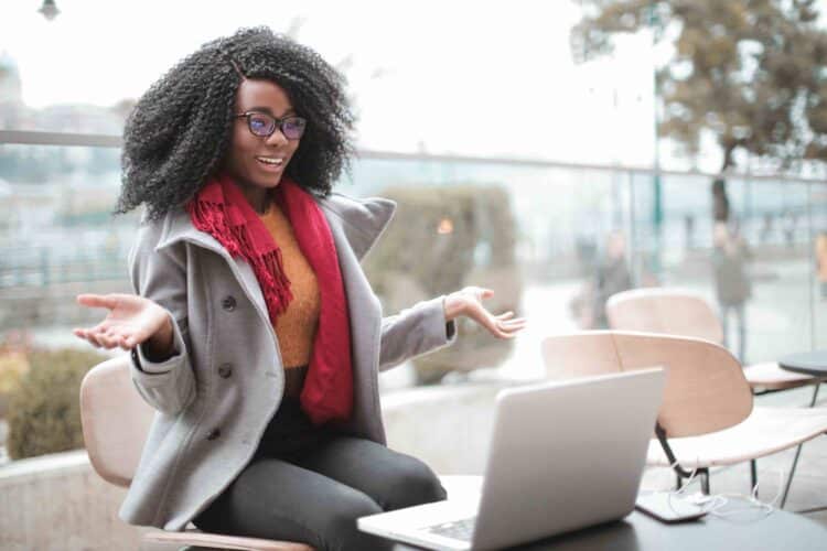 Woman on laptop building influence on LinkedIn with CFBR commenting for better reach