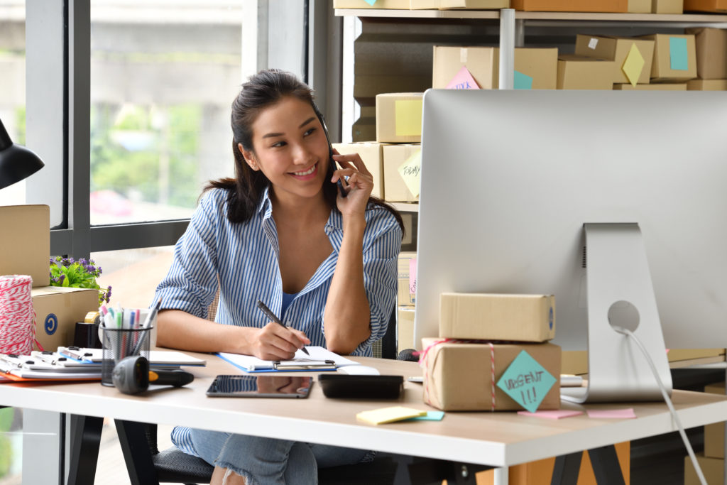 Woman business owner working with her computer at home.