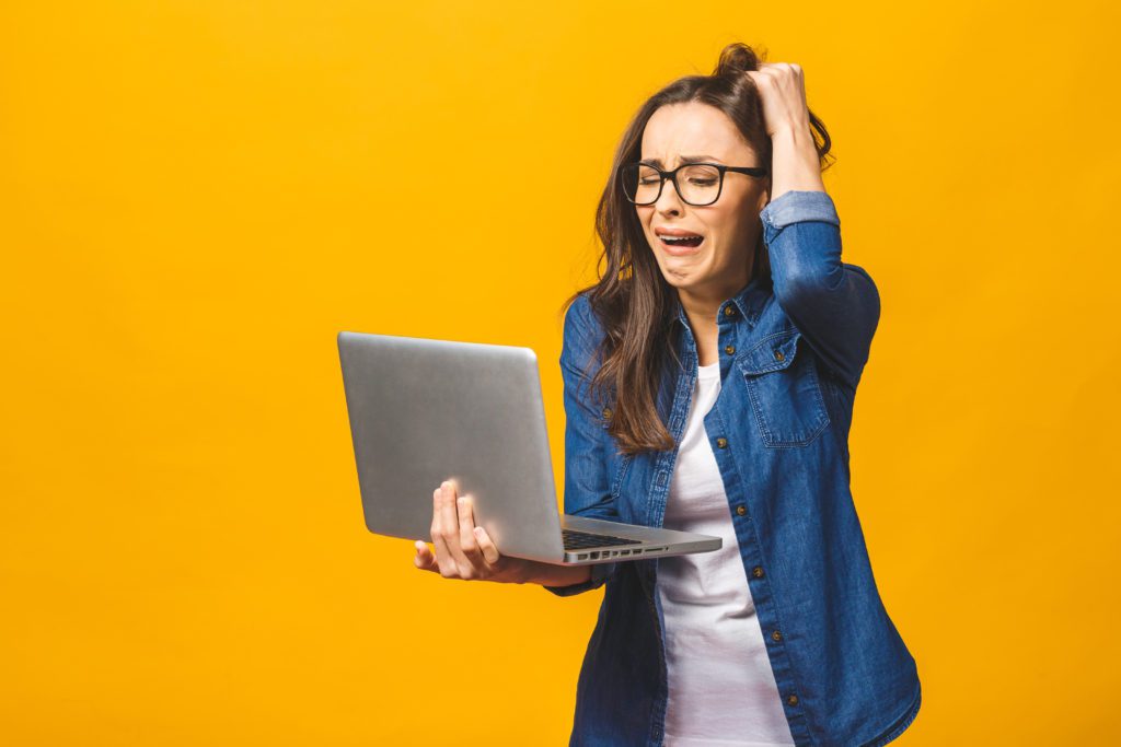 Woman having a work overload, yellow background.