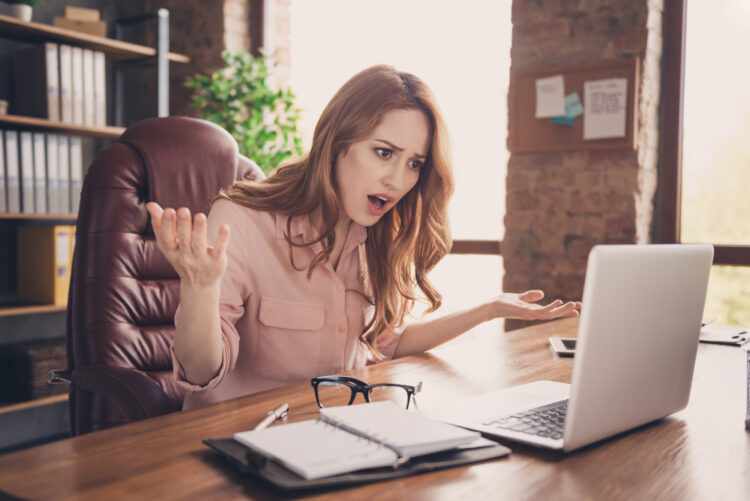 beautiful woman angry looking at laptop