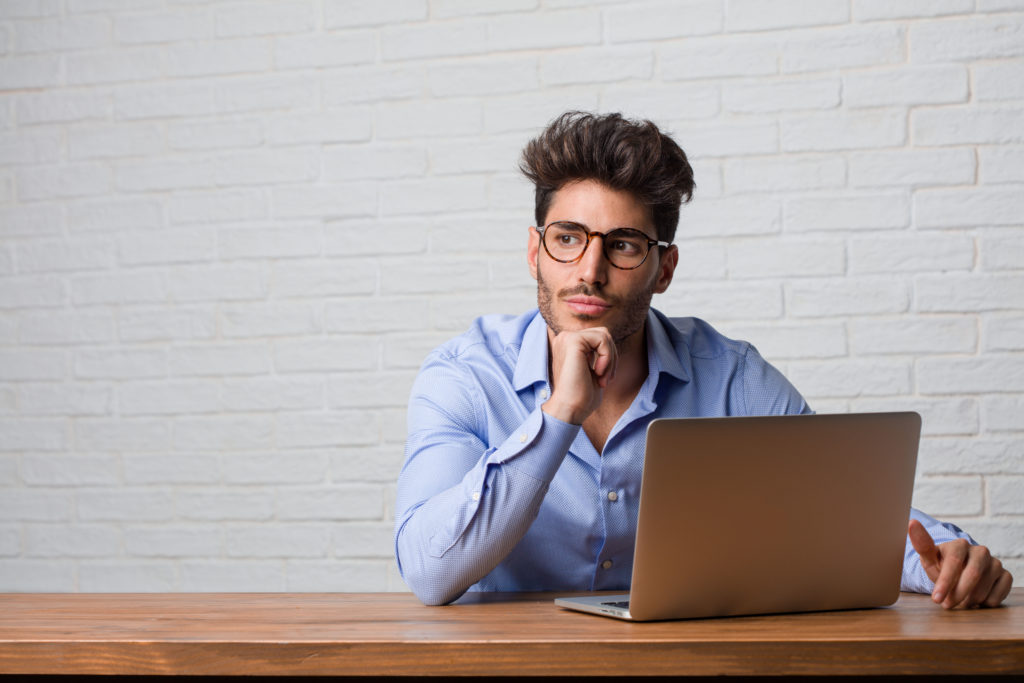 Young businessman thinking of a solution.