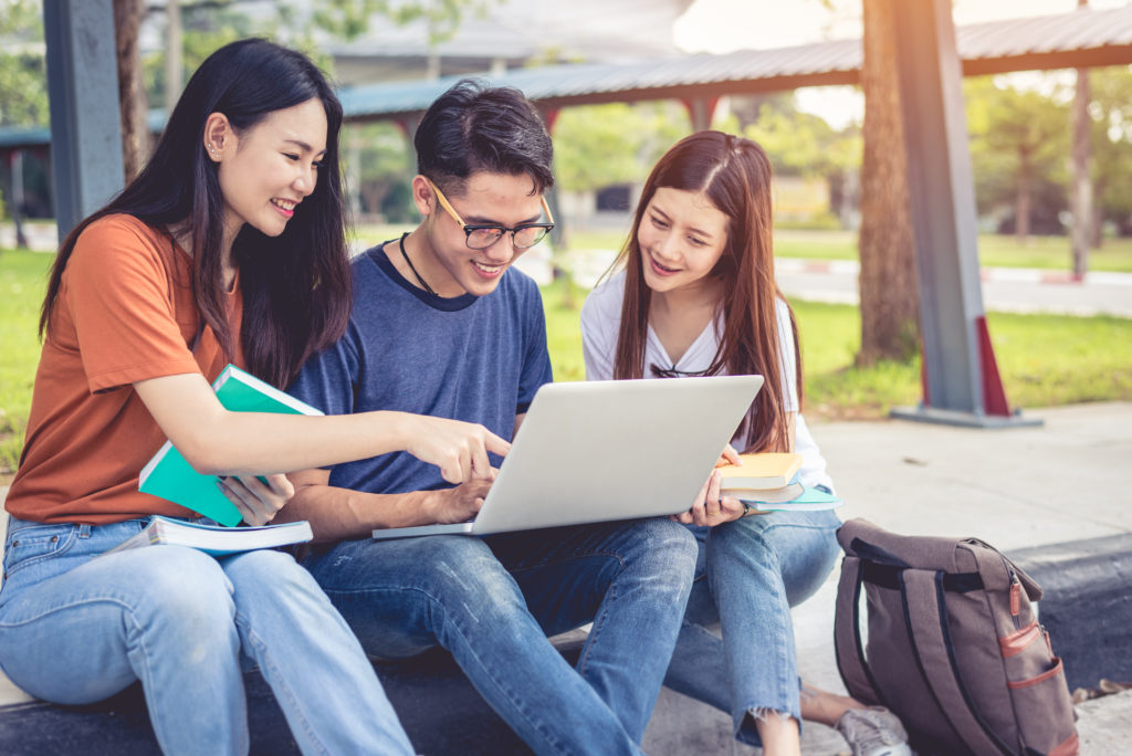 Young campus students learning and tutoring each other.