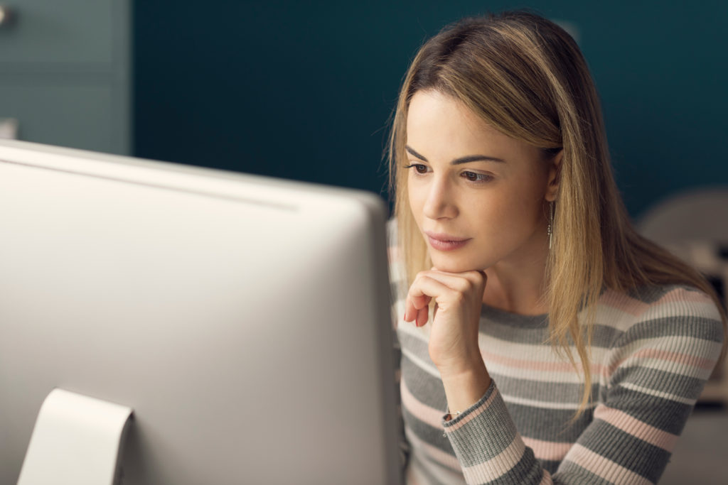 Young woman focused on her computer.