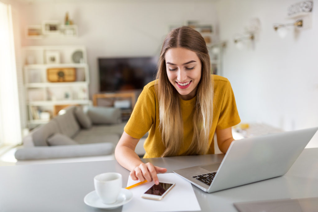 Young woman using her laptop at home.