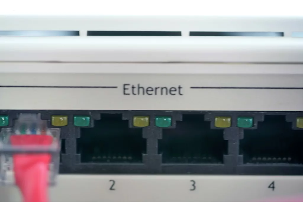 Ethernet ports on plastic panel of network router.