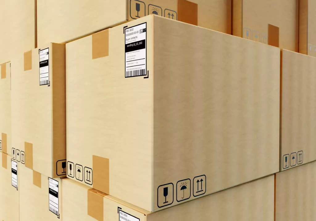 Boxes with barcodes in logistics center. Cardboard boxes with information stic