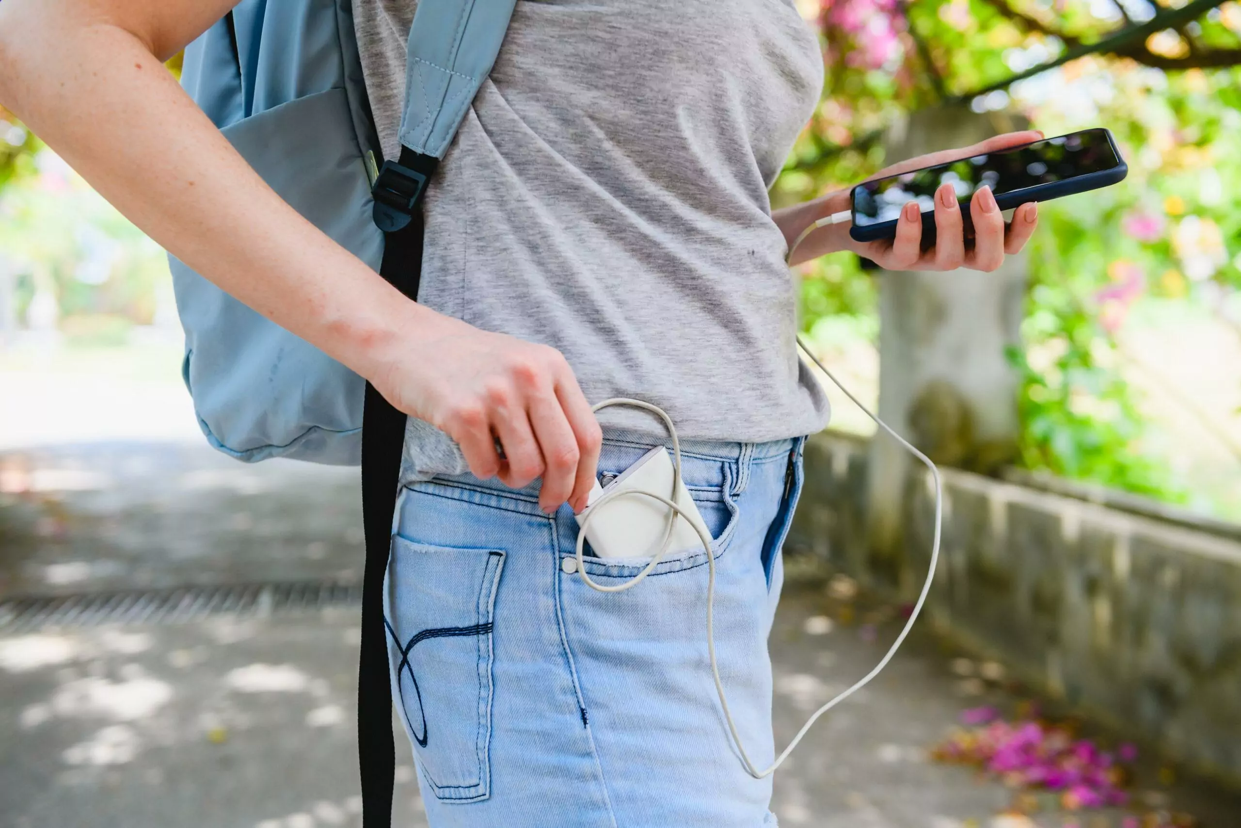 Female tourist connecting  smartphone to power bank