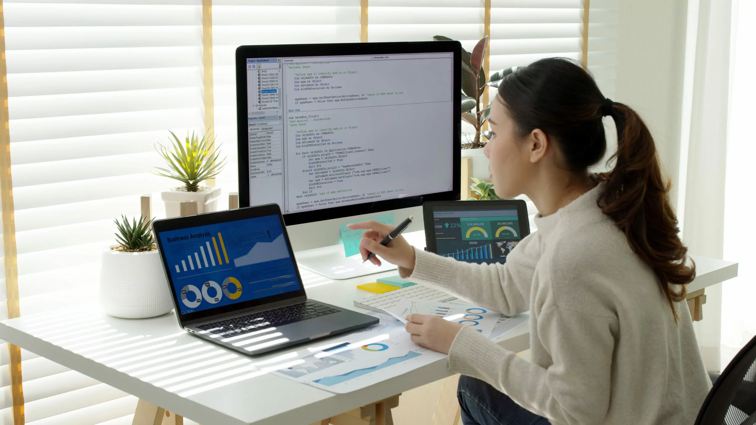 young woman working on a code at workstation at home