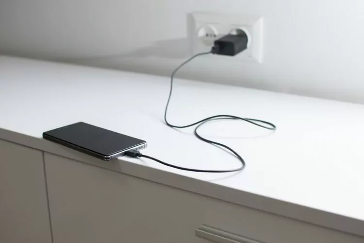 phone charging on top of drawer.