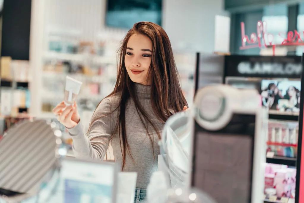 Girl buying products in the cosmetics store.