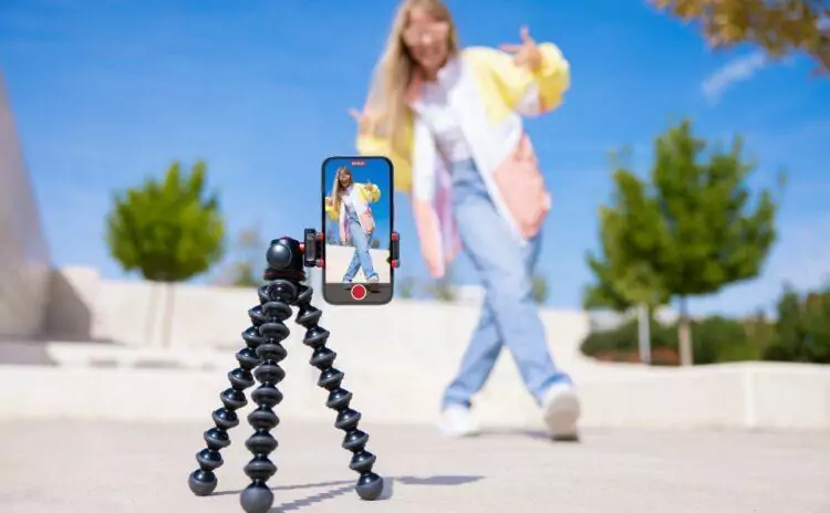 Teenage girl filming video of herself on mobile phone