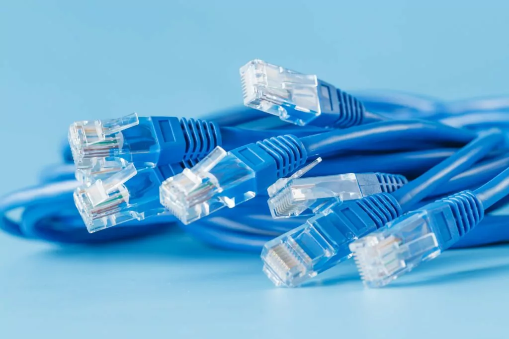 Blue computer ethernet cables with blue background.
