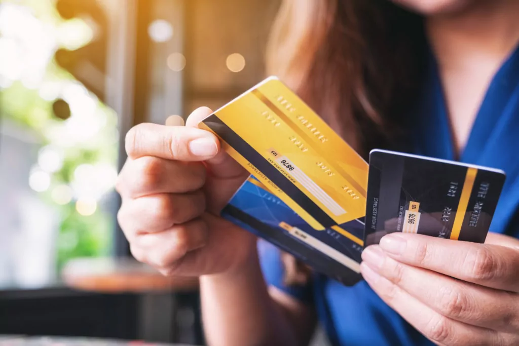 Woman holding and choosing credit card to use