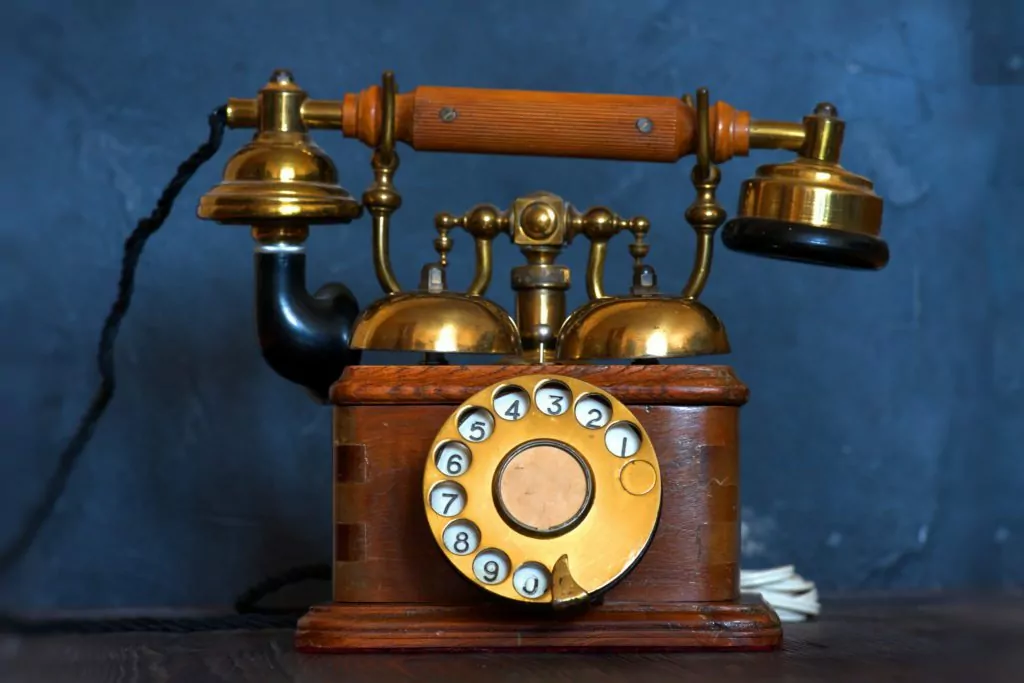 Old vintage telephone with blue background.