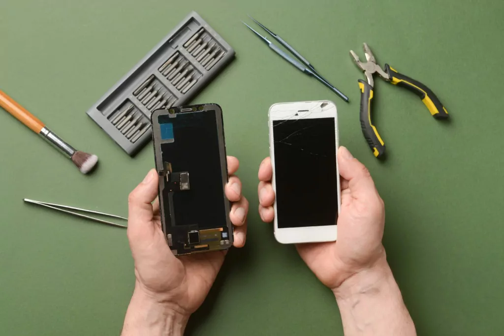 Male technician with disassembled mobile phone.