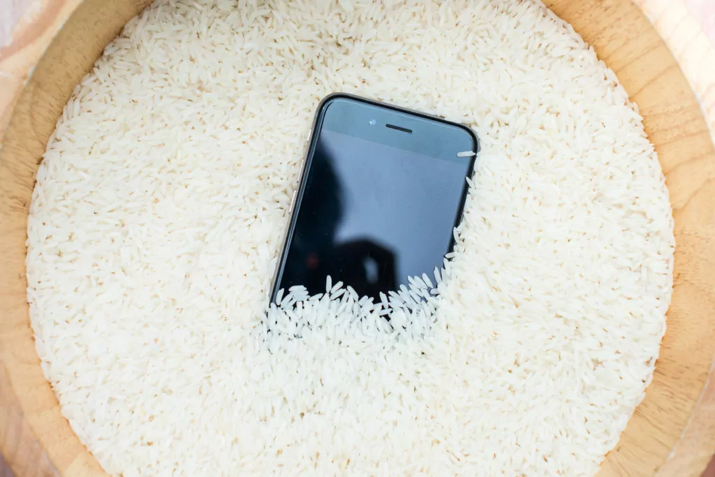 Phone in a bowl of uncooked rice.