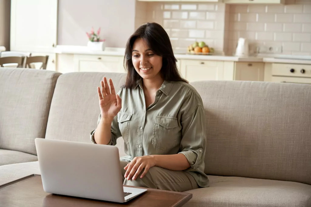 Smiling young woman having an online videoconference.