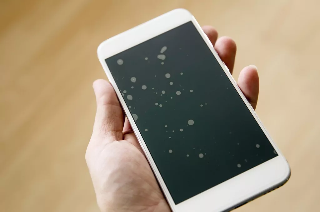 Badly installed smartphone protection screen with dust particles