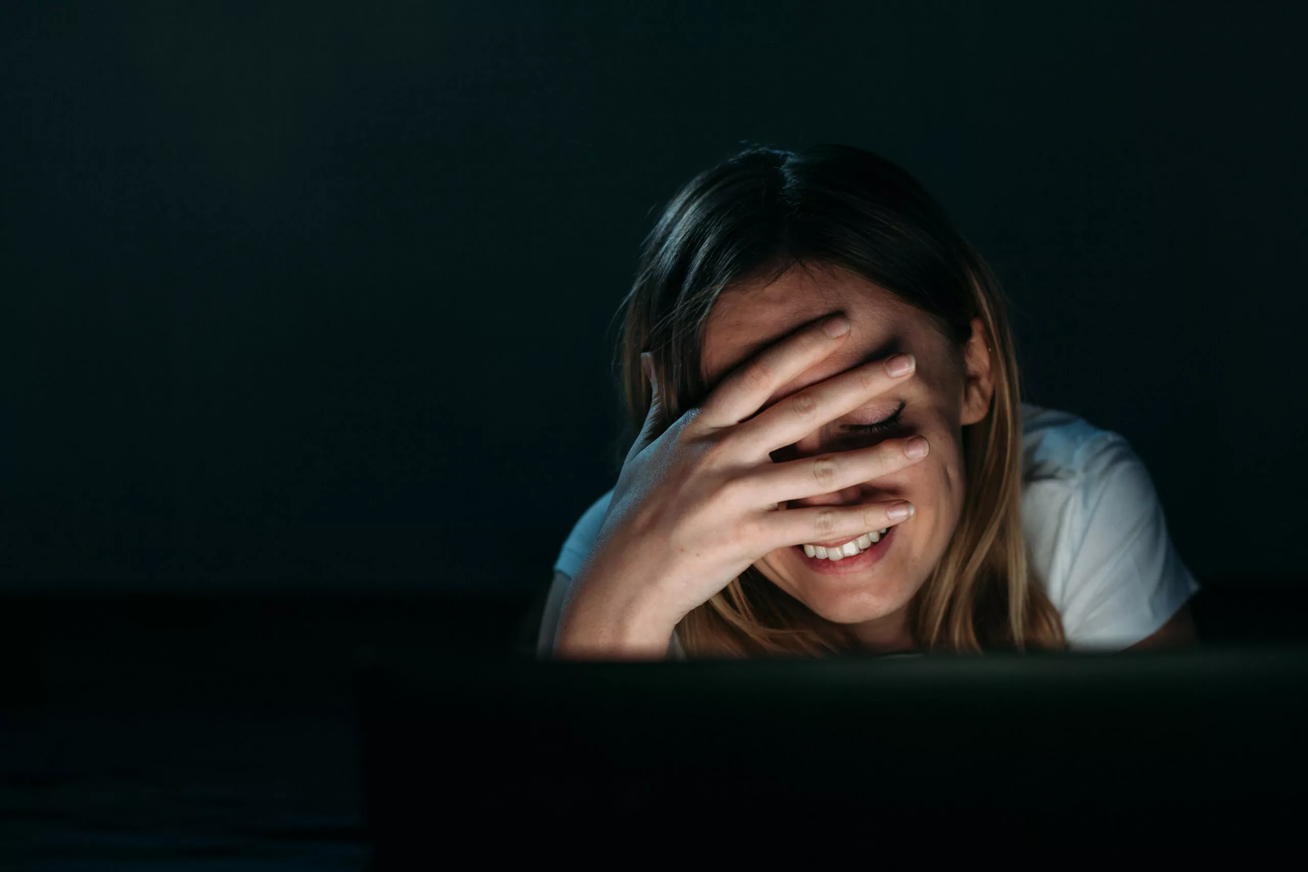 A cute woman facepalm looking at the laptop