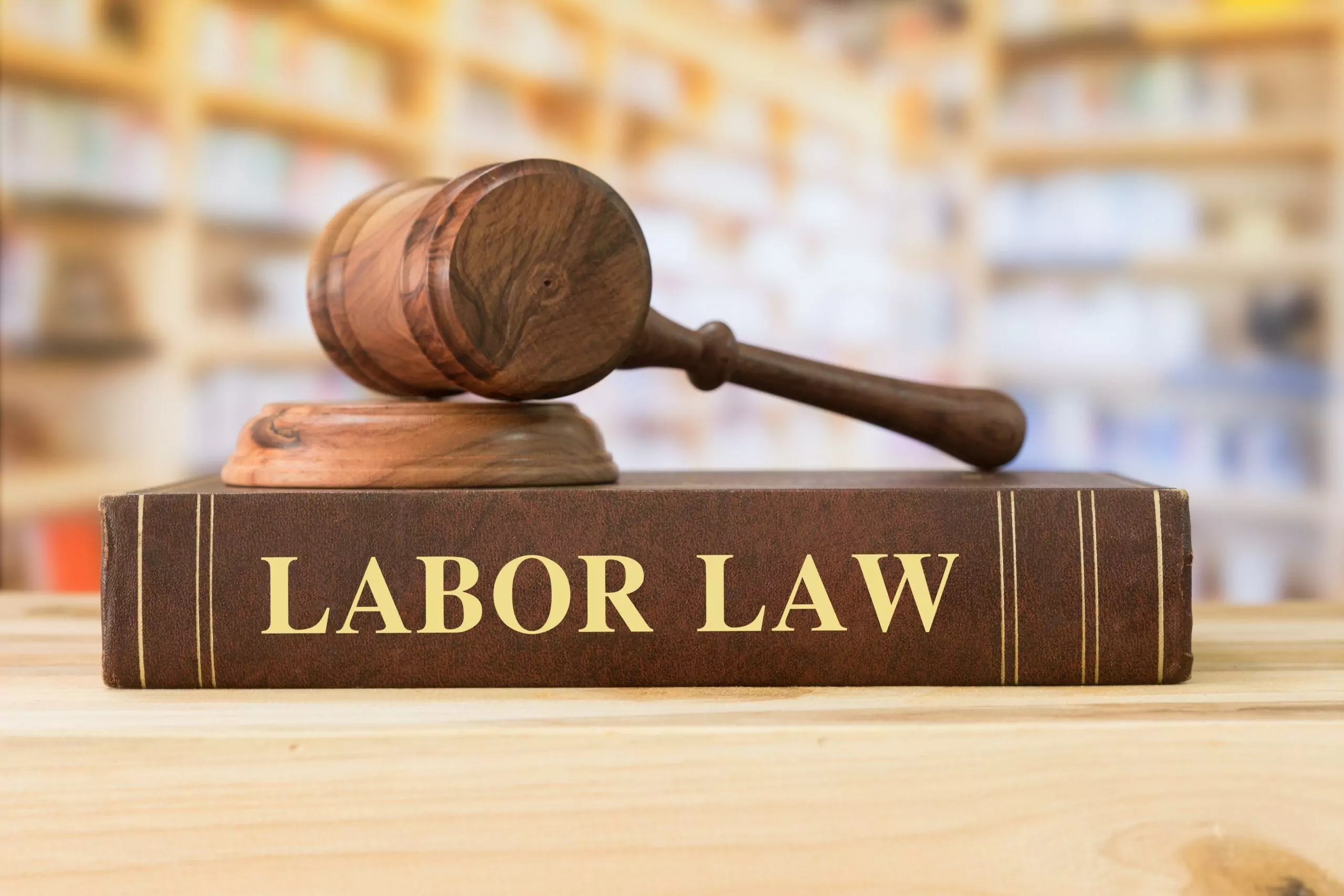 Labor Law books with a judges gavel on desk in the library